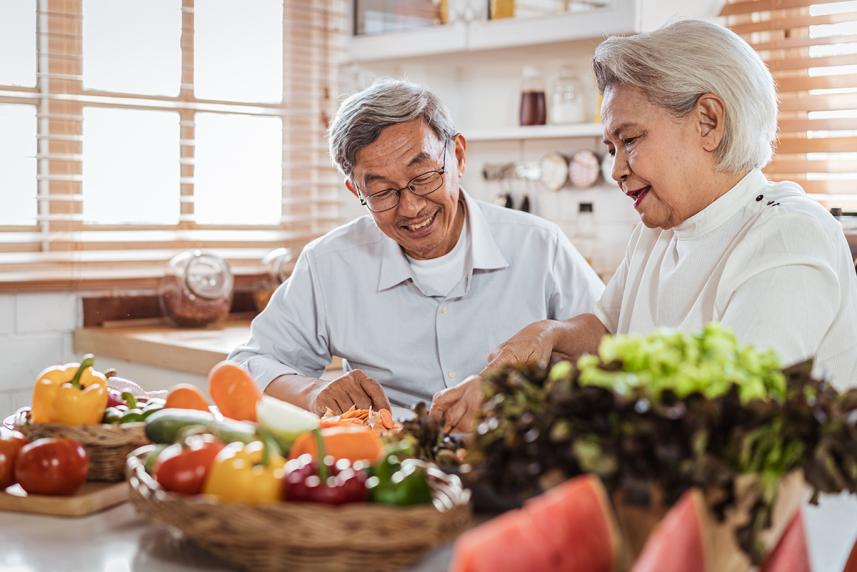 Senior couple cooking together in kitchen