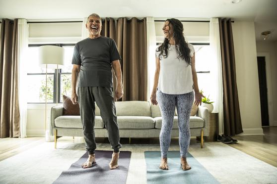 Couple doing yoga at home