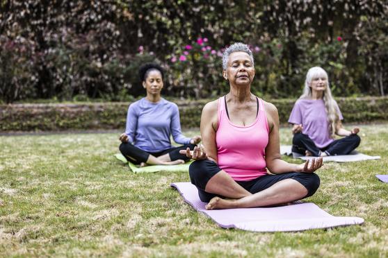 Senior woman doing yoga in the park